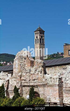 Historical Taslihan ruins with the old watch tower and minaret of Gazi Husrev mosque at the background, Sarajevo, Bosnia and Herzegovina Stock Photo