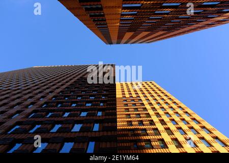High buildings photographed from below on the Amsterdam Zuidas on a sunny day with a blue and slightly cloudy sky. Stock Photo