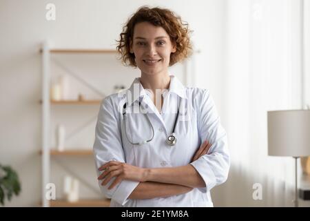 Portrait of smiling young doctor in white uniform. Stock Photo