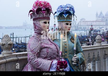 Woman dressed in traditional decorated costumes and painted masks during the Venice Carnival in Venice, Italy Stock Photo