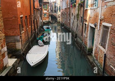 Old traditional Venetian brick buildings around a canal in Venice, Italy Stock Photo