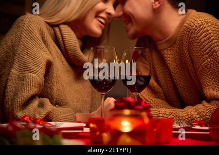 Happy couple celebrating Valentines day dining with red wine on Valentines day. Stock Photo