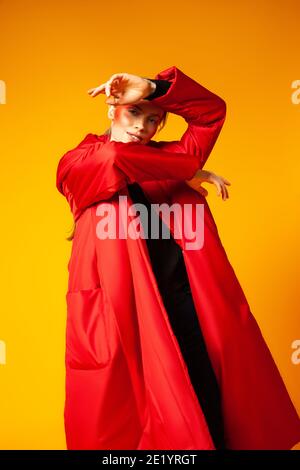 Female model in baggy coat and dancing Stock Photo