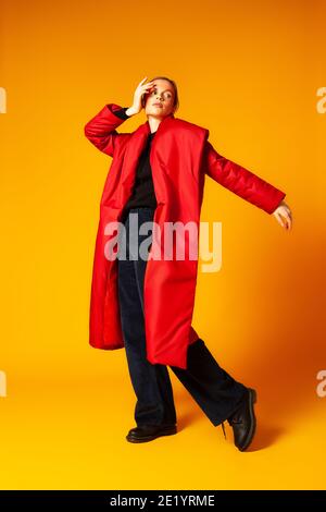 Female model in baggy coat and dancing Stock Photo