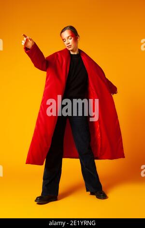 Female model in baggy coat and dancing Stock Photo