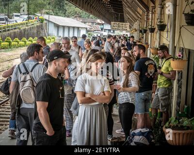 NANU-OYA, SRI LANKA - March 13, 2019: Young Caucasian tourists waiting for train on train station. Stock Photo