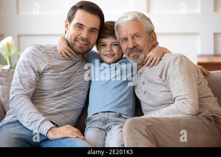 Portrait of happy three generations of men at home Stock Photo