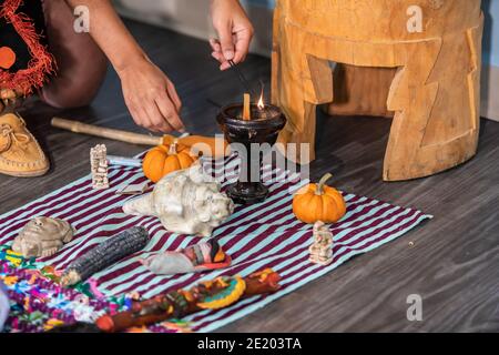 Moments from a native drum workshop. Close up of man's hands in front of a little shamanic altar lighting an incense stick between other objects. Stock Photo