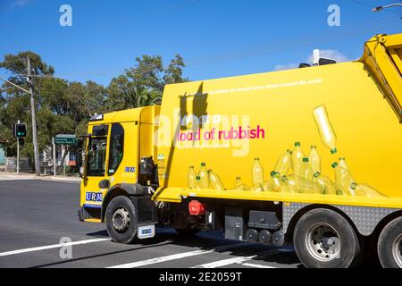 What a load of rubbish- council truck for collecting household waste garbage in Avalon Beach Sydney,Australia bright yellow refuse truck Stock Photo