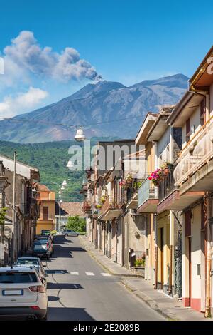 Typical sicilian street with a view at Etna volcano eruption in Piedimonte Etneo town, Sicily Stock Photo