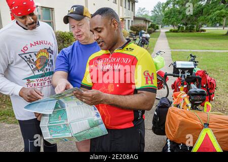 Alabama Mobile Brookley Center centre Underground Railroad Adventure,Bicycle Highway Route cyclists Black man men planning reading map, Stock Photo