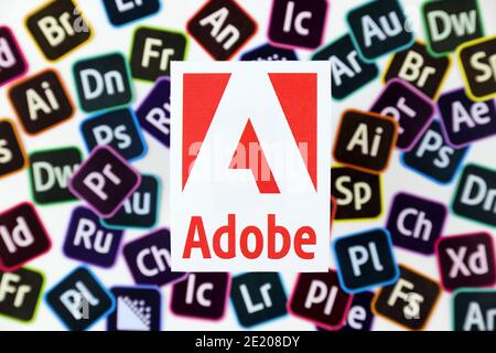 KHARKOV, UKRAINE - DECEMBER 26, 2020: Paper logos of most popular adobe products on white background. Photoshop illustrator bridge indesign premierepr Stock Photo