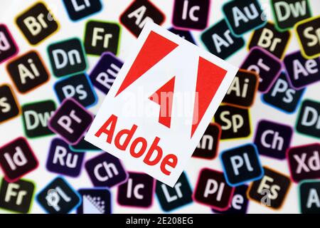 KHARKOV, UKRAINE - DECEMBER 26, 2020: Paper logos of most popular adobe products on white background. Photoshop illustrator bridge indesign premierepr Stock Photo