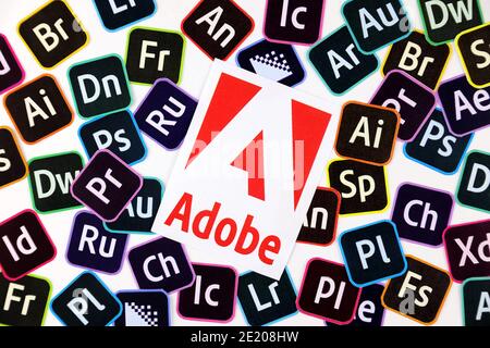 KHARKOV, UKRAINE - DECEMBER 26, 2020: Paper logos of most popular adobe products on white background. Photoshop illustrator bridge indesign premierepr Stock Photo