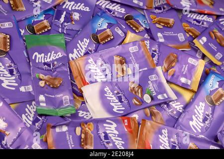 KHARKOV, UKRAINE - DECEMBER 8, 2020: Many wrappings of purple Milka chocolate. Milka is a Swiss brand of chocolate confection manufactured internation Stock Photo