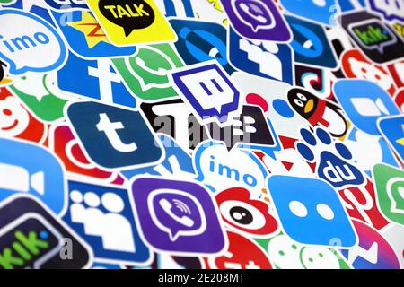 KHARKOV, UKRAINE - DECEMBER 26, 2020: Paper logos of most popular social networks and mobile messengers on wooden background. Facebook instagram youtu Stock Photo