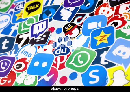 KHARKOV, UKRAINE - DECEMBER 26, 2020: Paper logos of most popular social networks and mobile messengers on wooden background. Facebook instagram youtu Stock Photo