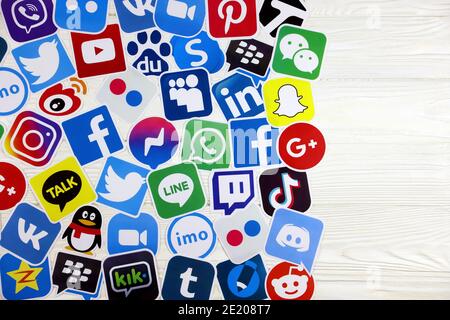 KHARKOV, UKRAINE - DECEMBER 26, 2020: Paper logos of most popular social networks and mobile messengers on wooden background. Facebook instagram youtu Stock Photo