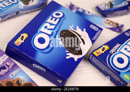 KHARKOV, UKRAINE - DECEMBER 8, 2020: Oreo sandwich cookies and blue product boxes on white table. Oreo is a sandwich cookie with a sweet cream is the