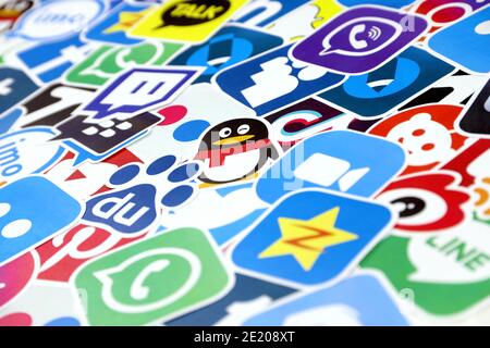 KHARKOV, UKRAINE - DECEMBER 26, 2020: Paper logos of most popular social networks and mobile messengers on wooden background. Facebook instagram youtu Stock Photo