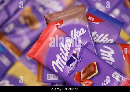 KHARKOV, UKRAINE - DECEMBER 8, 2020: Many wrappings of purple Milka chocolate. Milka is a Swiss brand of chocolate confection manufactured internation Stock Photo