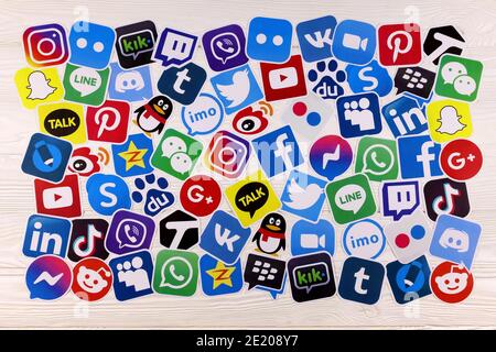 KHARKOV, UKRAINE - DECEMBER 26, 2020: Paper logos of most popular social networks and mobile messengers on wooden background. Facebook instagram youtu Stock Photo