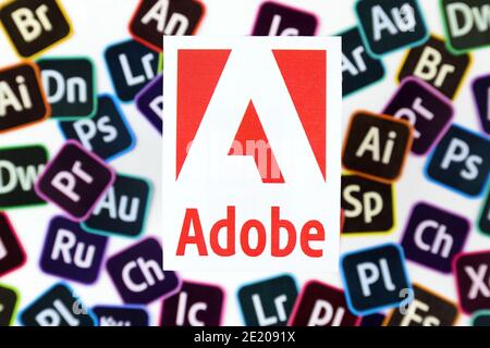 KHARKOV, UKRAINE - DECEMBER 26, 2020: Paper logos of most popular adobe products on white background. Photoshop illustrator bridge indesign premierepr Stock Photo