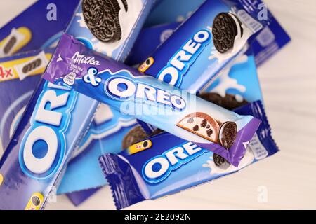KHARKOV, UKRAINE - DECEMBER 8, 2020: Oreo sandwich cookies and blue product boxes on white table. Oreo is a sandwich cookie with a sweet cream is the