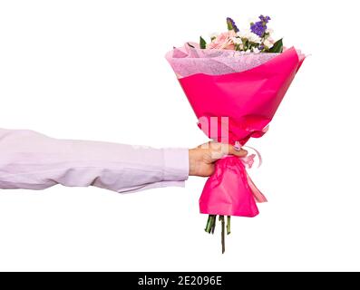 Hand holding bunch of roses isolated against white background. Beautiful pink bouquet close-up in a man's hand. Stock Photo