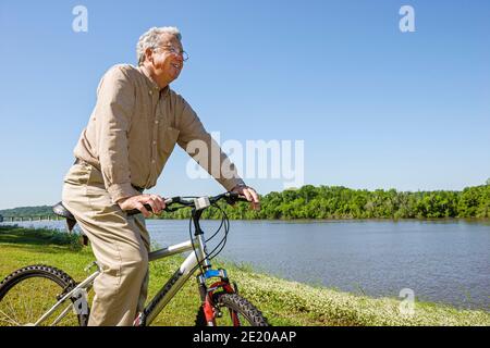 Alabama Monroeville Isaac Creek Campground,Claiborne Lake Alabama River Lakes water,senior man bicycle riding bike, Stock Photo