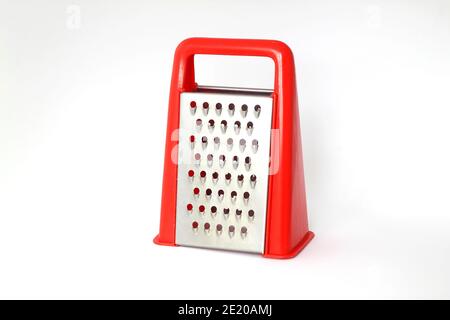 Red grater stainless steel closeup isolated on white background. Stock Photo