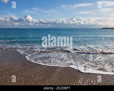 Clouds on the horizon above sea. Evening surf at sandy beach. Landscape with sea and clouds Stock Photo