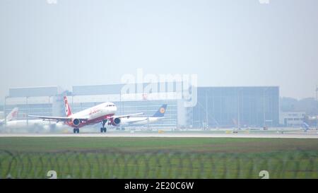 MUNICH, GERMANY - 11 OCTOBER 2015: Passenger plane of Air Berlin low-cost airline touching down runway at Munich international airport MUC Stock Photo