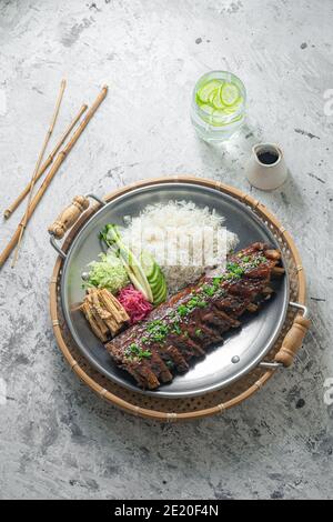 Asian style pork short ribs with rice and vegetables. Stock Photo