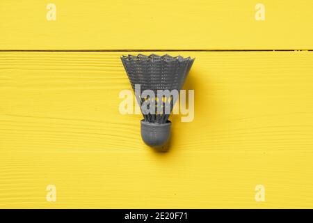 Gray shuttlecock on yellow background top view Stock Photo