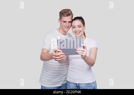 Couple Using Tablet Isolated. Couple Shopping Online. Stock Photo