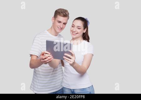 Couple Using Tablet Isolated. Couple Shopping Online. Stock Photo