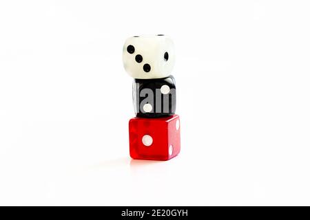 Three multi coloured dice isolated on white background with copy space. The dice are stacked on top of each other, showing sequence of 1,2,3 Stock Photo