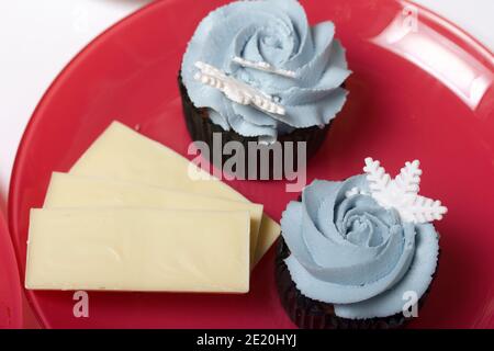 Muffin with cream cheese cream. Decorated with a marshmallow snowflake. Stock Photo