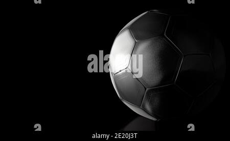 Metal-looking soccer ball illuminated from the left on a reflective black surface. 3d illustration Stock Photo