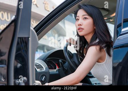 Open the door of the pretty young woman Stock Photo