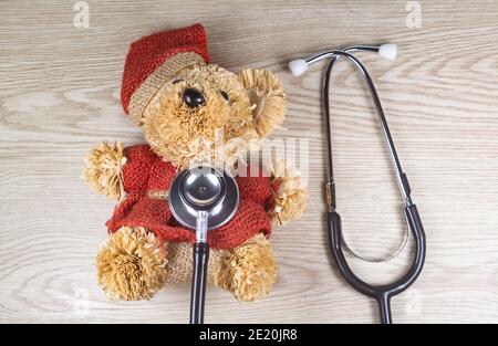 Teddy bear and stethoscope as concept for pediatric healthcare Stock Photo