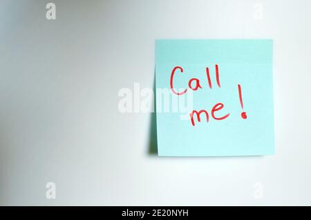 Call me written by hand and put on the white wall Stock Photo