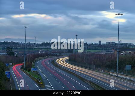 Beautiful very long exposure evening view of light trails of vehicles on motorway M50 Dublin, Ireland. Transportation during Level 5 in Dublin Stock Photo
