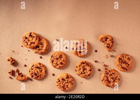 Chocolate chip cookies on a brown paper background, shot from above with copy space Stock Photo