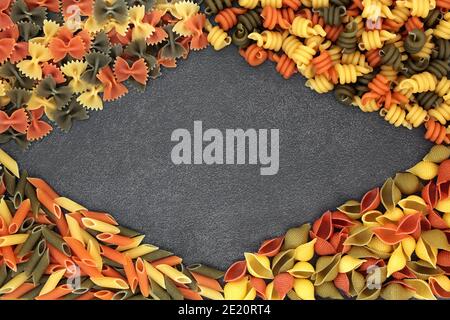 Italian healthy tricolore food pasta abstract background border on slate.  Flat lay, top view. Stock Photo