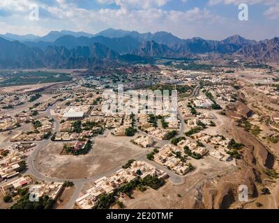 Hatta town aerial cityscape surrounded by Hajar mountains in Hatta enclave of Dubai in the United Arab Emirates aerial view Stock Photo