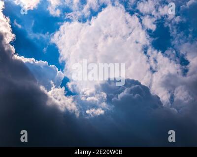 Sun rays shining through thick cloudy sky. Stock Photo