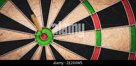 Success and business target concept : Close view of dartboard with dart in the bulls eye. Stock Photo