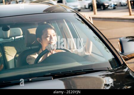 Say "hello" to drive young woman Stock Photo